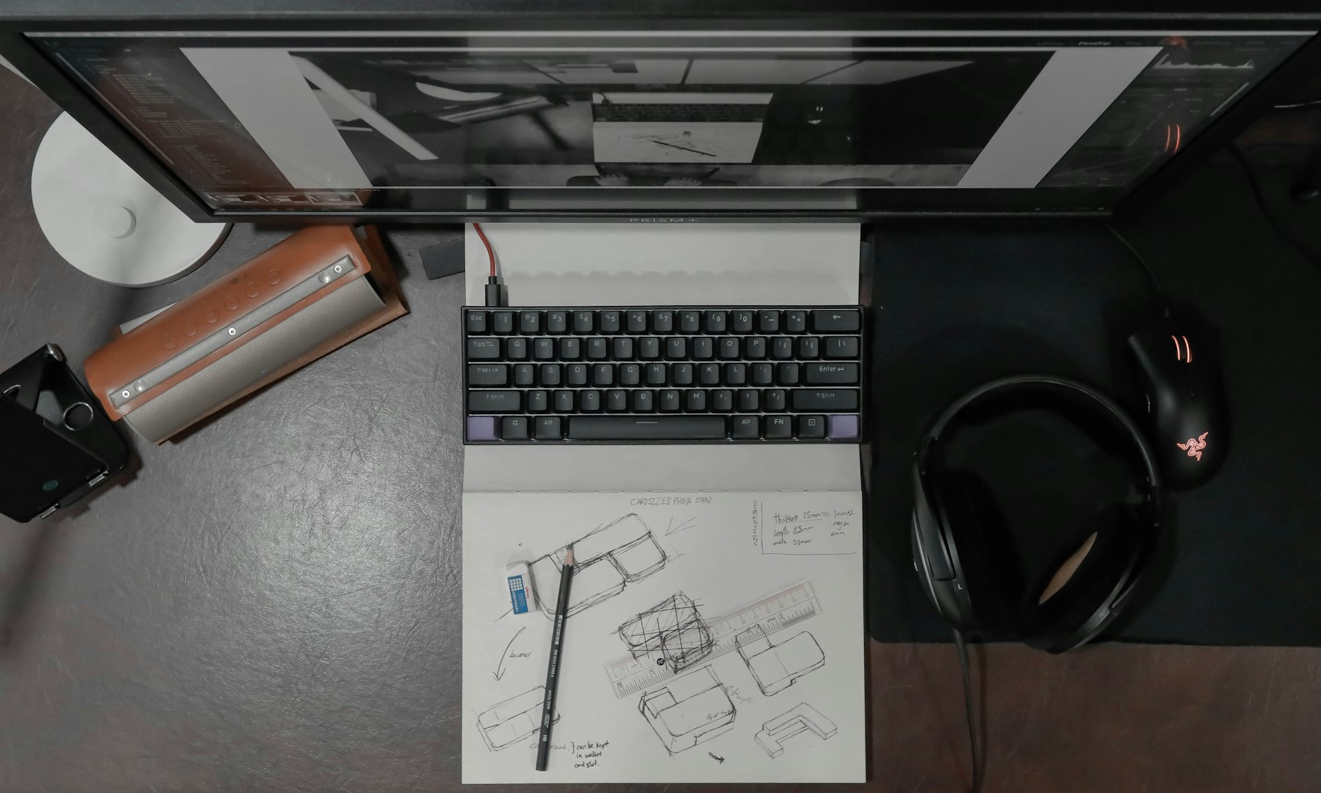 Architectural blueprints on a desk with drafting tools and keyboard